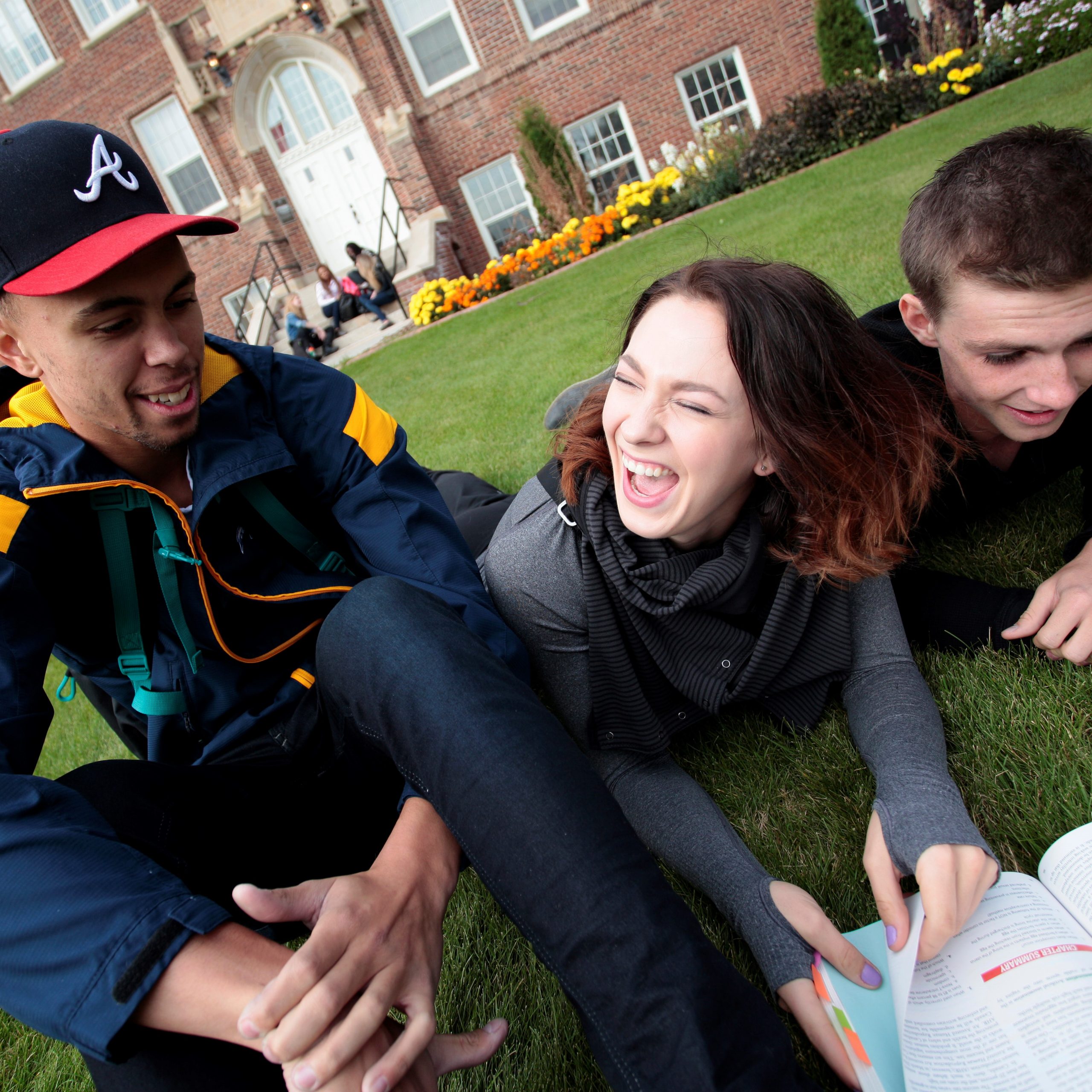 Students hanging out together on the front lawn of Concordia University of Edmonton.