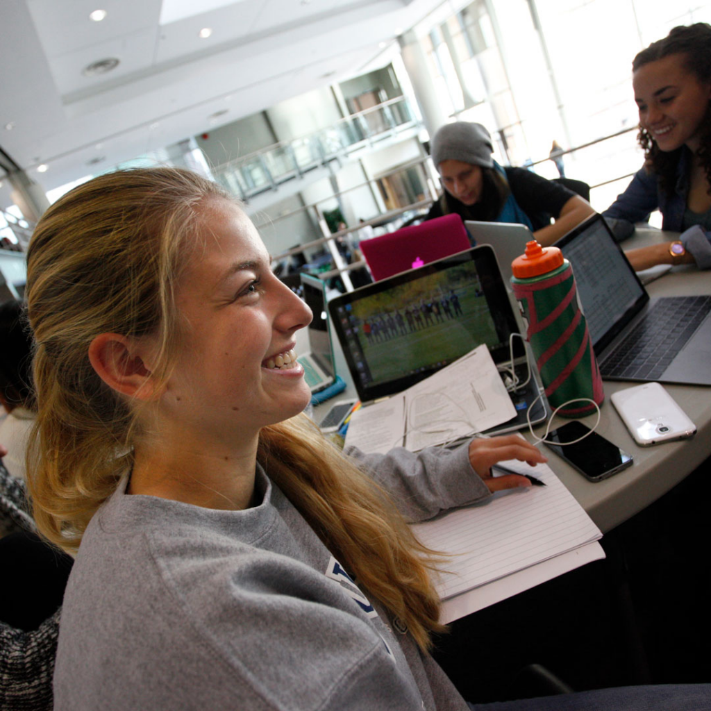 Undergraduate students sit around a table in CUE's Tegler Studen Centre