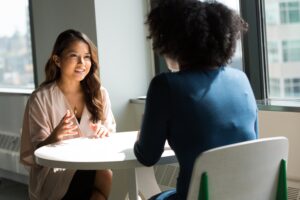 Women talking across a table